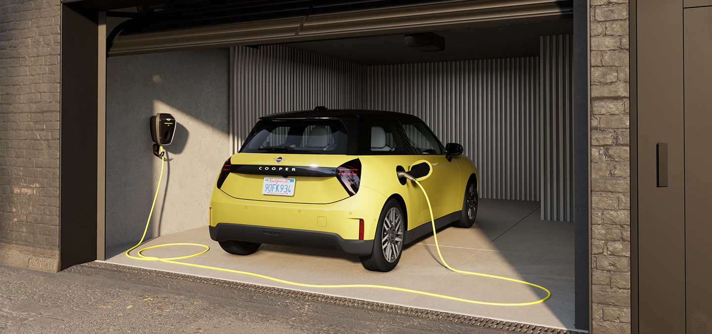 MINI Cooper Electric in Sunny Side Yellow charging in a garage.