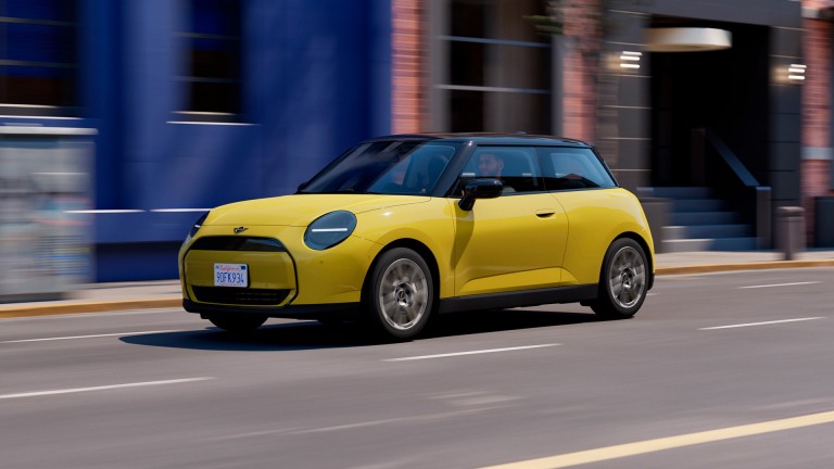 MINI Cooper in Sunny Side Yellow driving on an urban street.